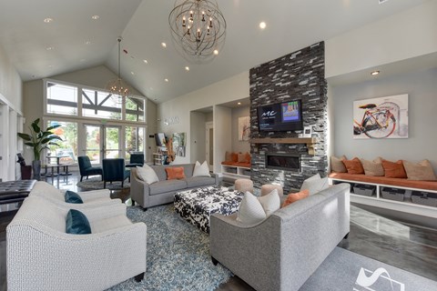 Clubhouse Room with Gray Sofa and Chairs, Full View Glass Doors, Wall Mounted Flatscreen TV, Carpet and Wood Inspired floor